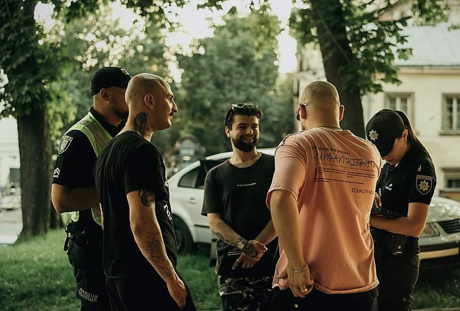 A group of people casually interacting with police officers in a park setting in Lviv, Ukr — legat de Politica extrema dreapta
